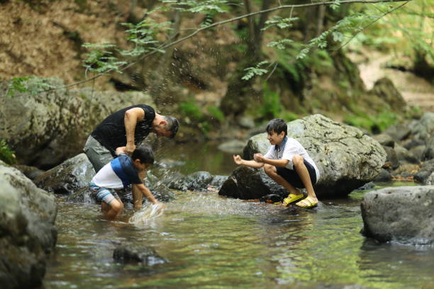 istock Father and boys hiking in the forest 1730220473
