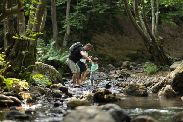 istock Father and boys hiking in the forest 1730222046