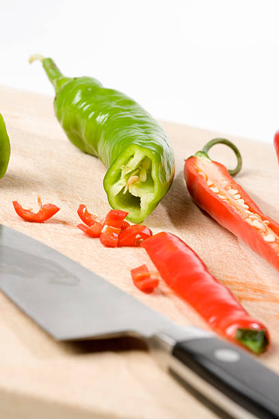 Fresh chili's on cutting board. Fresh Chili's on cutting board. Vertical. Selective focus. anaheim pepper photos stock pictures, royalty-free photos & images