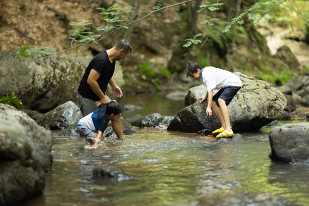 istock Father and boys hiking in the forest 1730222598