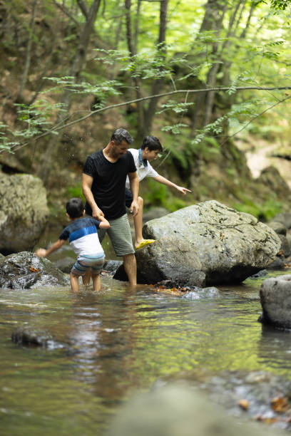 istock Father and boys hiking in the forest 1730223122