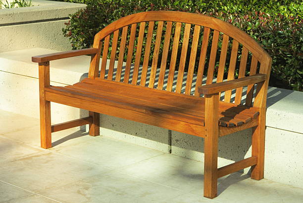Wood bench in dappled sunrise light at modern office park.  San Mateo, California, 2008.