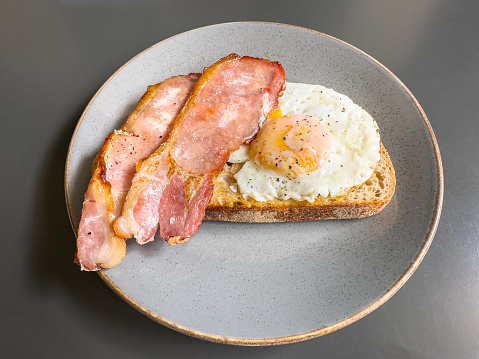 Toasted bread with fried eggs and bacon