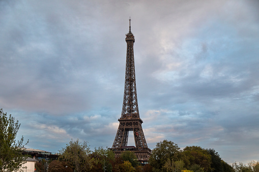 Eiffel Tower with a moody sky at dusk, shot from the Seine River, Paris, France