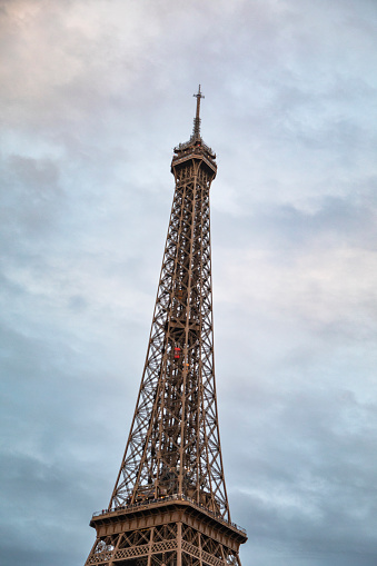 Eiffel Tower with a moody sky at dusk, shot from the Seine River, Paris, France