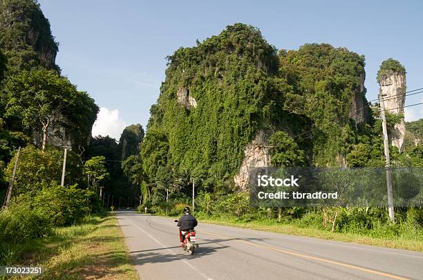 Motorbike Riding Through Karst Rock Formations Near Krabi In Thailand Stock Photo - Download Image Now