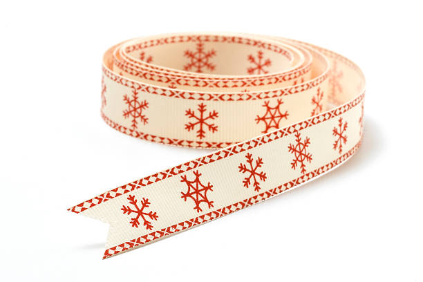 Christmas red ribbon with white snowflakes isolated.