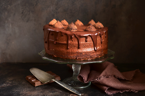 Homemade delicious chocolate cake Truffel on a dark slate, stone or concrete background