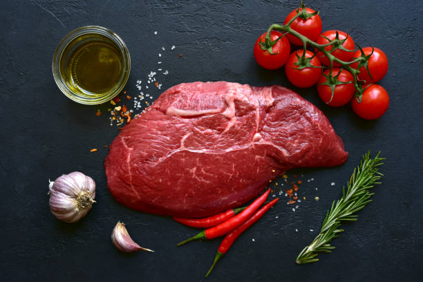 istock Raw organic marbled beef steak with spices and vegetables  . Top view with copy space. 1730238418