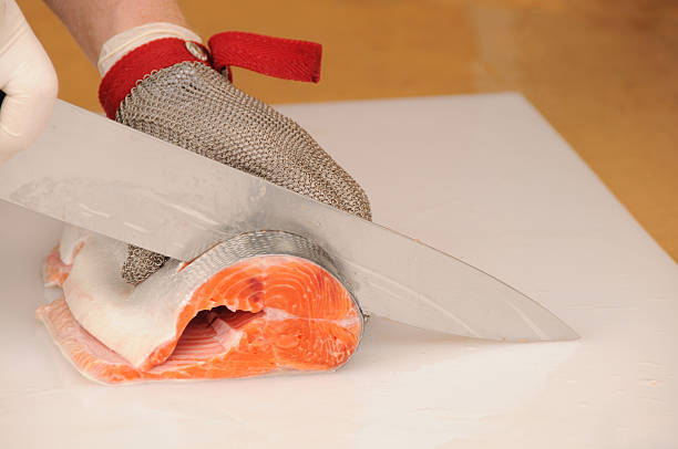 slicing salmon - uitbeenhandschoen stockfoto's en -beelden