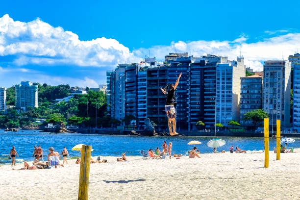 A young man performs in a tighrope in a Niteroi beach, Brazil