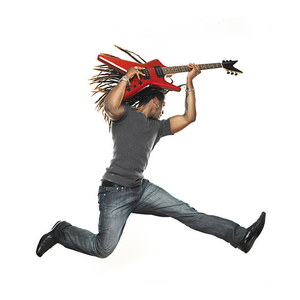 istock Man playing electric guitar and jumping 173024073