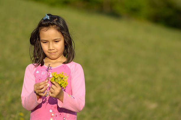 istock Young girl looking at her flowers 173025356