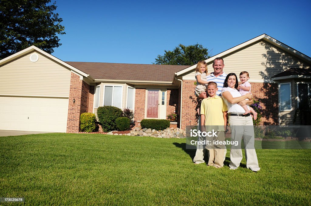 Happy Family A happy family standing in front of their home on a sunny, summer day. 25-29 Years Stock Photo