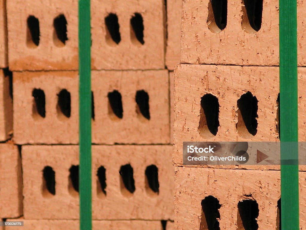 Bricks . "Stacks of newly delivered red bricks.Focus on the bricks on the right hand side, those on the left are out of focus to provide a 3 dimensional effect and to give space for copy." Architecture Stock Photo