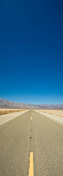 percorso per deep blue - arid climate asphalt barren blue foto e immagini stock