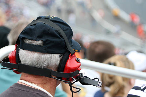 Senior Man With Earmuffs at Racing Event