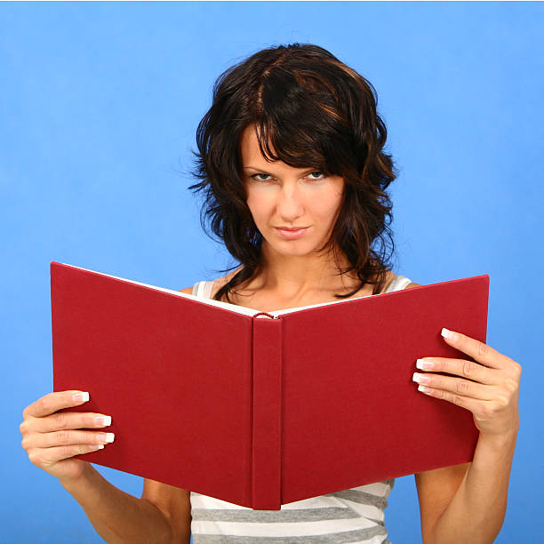 istock Beautiful woman reading a book 173028000