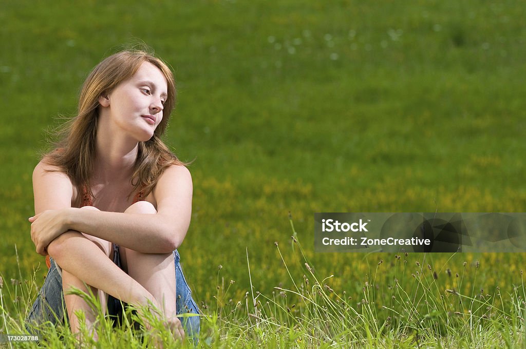 young beautiful girl saddness or meditation in field  Anxiety Stock Photo