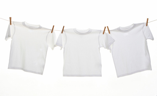 Three white t-shirts hanging on a line with clothes pins