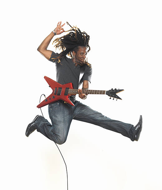 istock Man playing electric guitar and jumping 173029426