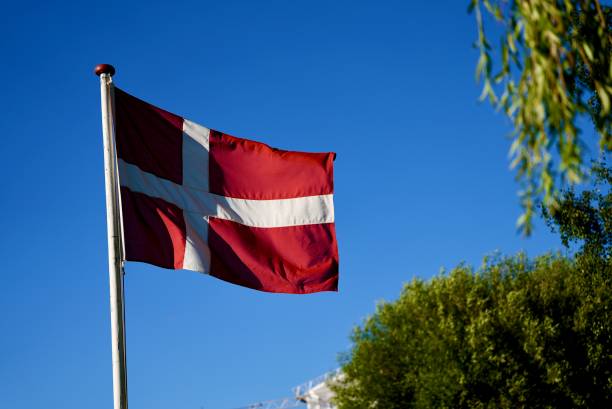 istock Danish flag on blue sky. Flag of Denmark 1730298513