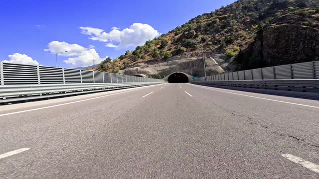 Car perspective exiting light tunnel. 4K