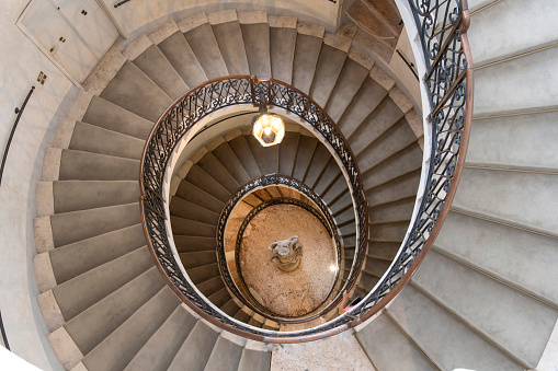 Verona, Italy-June 12, 2023; Birds eye view of the helicoidal stone staircase that runs from the basement up to the top floor of Palazzo Maffei now a museum