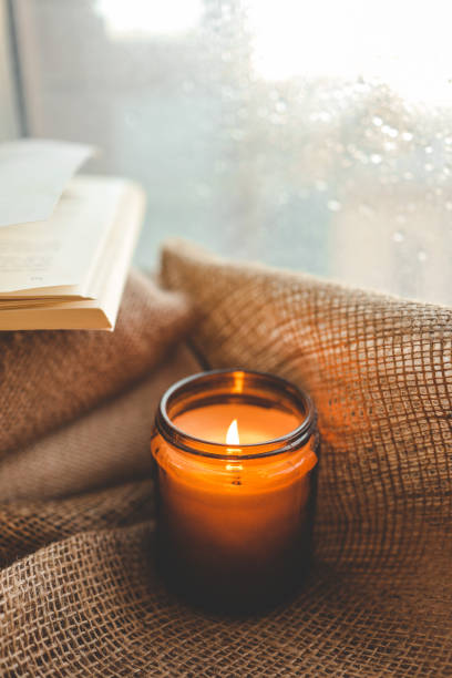 istock Burning candle close-up by the window 1730311082
