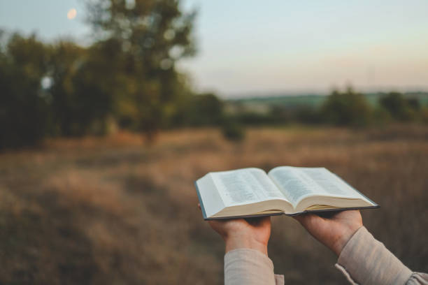 istock Bible in hands in nature, Christian concept 1730311989