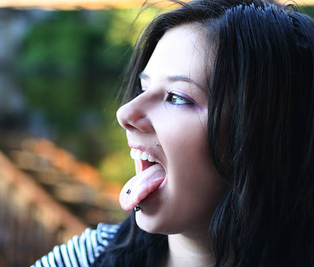 Portrait of a young woman sticking tongue out