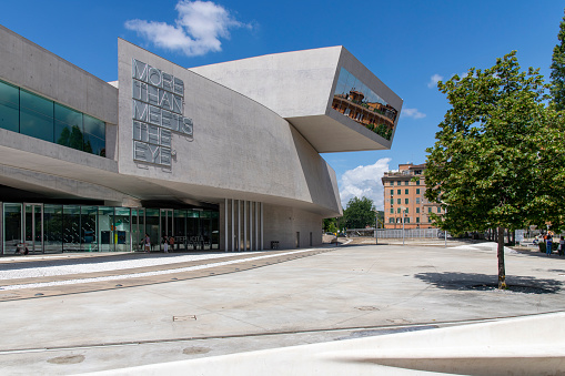 Rome, Italy-June 10, 2023; Façade of MAXXI national museum of 21st-century contemporary art and architecture, building designed by Zaha Hadid, reflection of Flaminio neighborhood houses in window