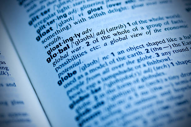 istock Page in dictionary, focus on GLOBAL, blue toned. 173033150