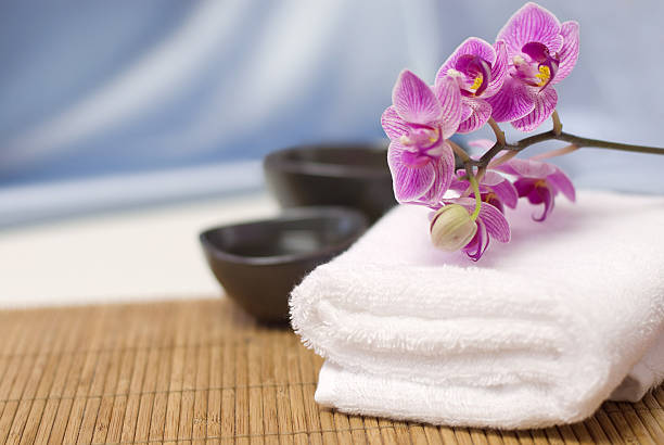 Spa towel withy orchid on Bambu spa Towel and Flower spa room stock pictures, royalty-free photos & images