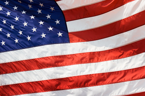 Subject: Close-up of a section of a United States flag waving in the breeze