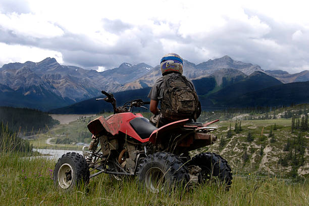 Mountain Ashlar A man looking at the mountains on his quad. quadbike stock pictures, royalty-free photos & images