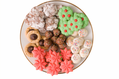 Several kinds of Christmas cookies on a glass plate, spruce twig decoration
