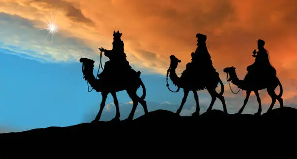 The three wise men on their camels with a dramatic sky.
