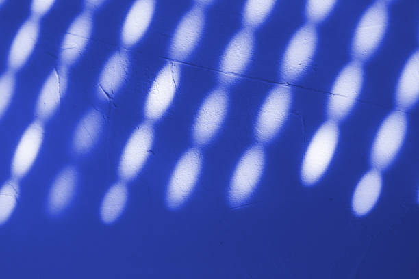 Shadow from the blinds on the concrete wall on a sunny day, Interior design. Abstract background, banner, pattern. Acid Blue, white colors.  Copy space.