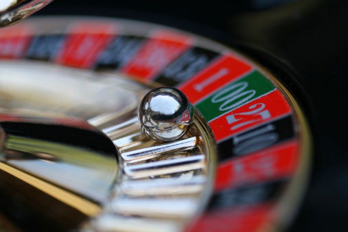 spinning roulette wheel with selective focus on ball landed on double zero.  