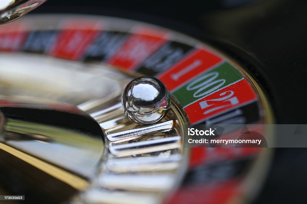 A roulette wheel with the ball on 00 spinning roulette wheel with selective focus on ball landed on double zero.   Roulette Stock Photo