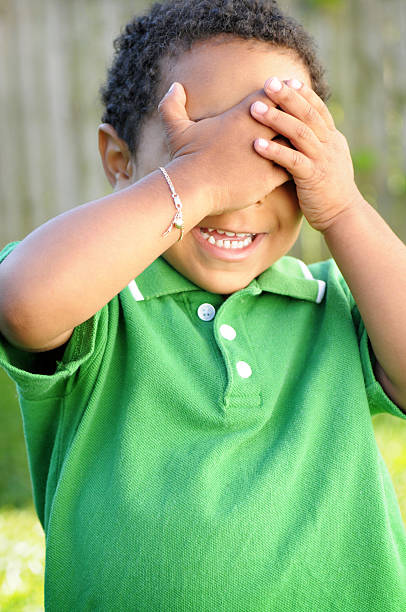 istock Happy Little Boy Covering Face with His Hands 173036028