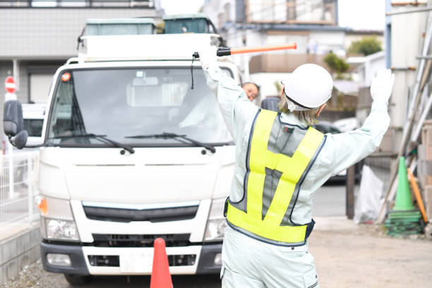 istock A man who is a traffic director guiding trucks with guide lights 1730371584