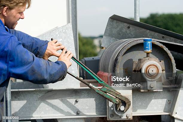 Repairman And Mechanic At Work With His Tools Stock Photo - Download Image Now - Conveyor Belt, Engineer, Adult