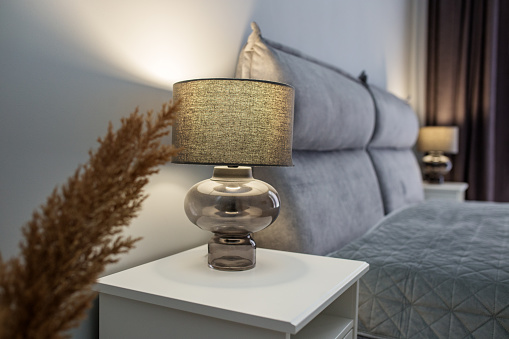 Night light on bedside table. Bedroom interior elements. Cozy home