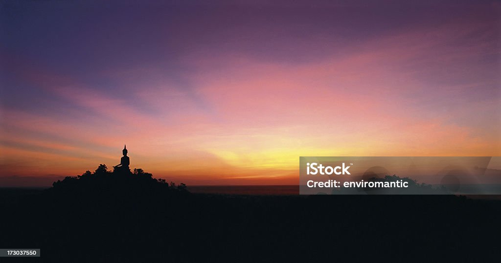 Large Buddha image, silhouetted in a Thai landscape. A Silhouette of a large Buddha image in a Thai landscape taken during a stunning sunset.  Asia Stock Photo