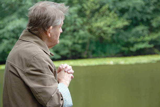 istock senior praying outdoors 173038051