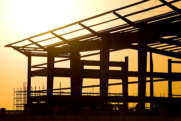 Sunset behind a construction site for large building stock photo