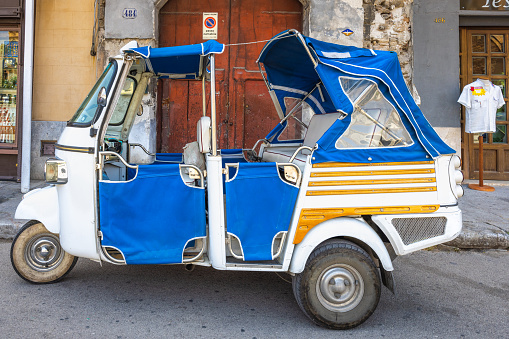 PALERMO, ITALY - JULY 18, 2023: Three-wheeled car on the street.