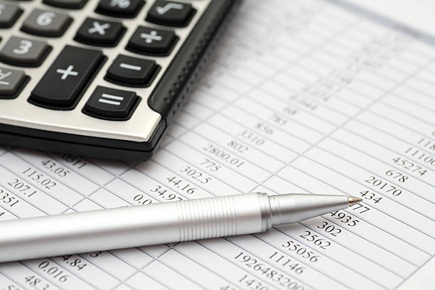 istock Financial statements with calculator and pen on top 173039431